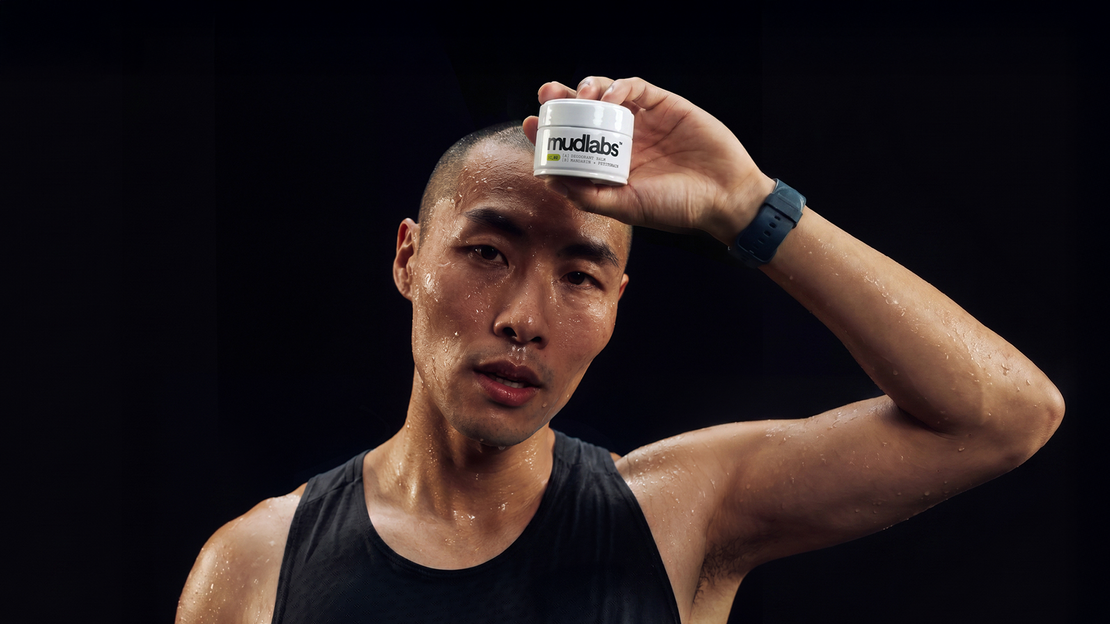 Man holding Mudlabs deodorant balm after workout